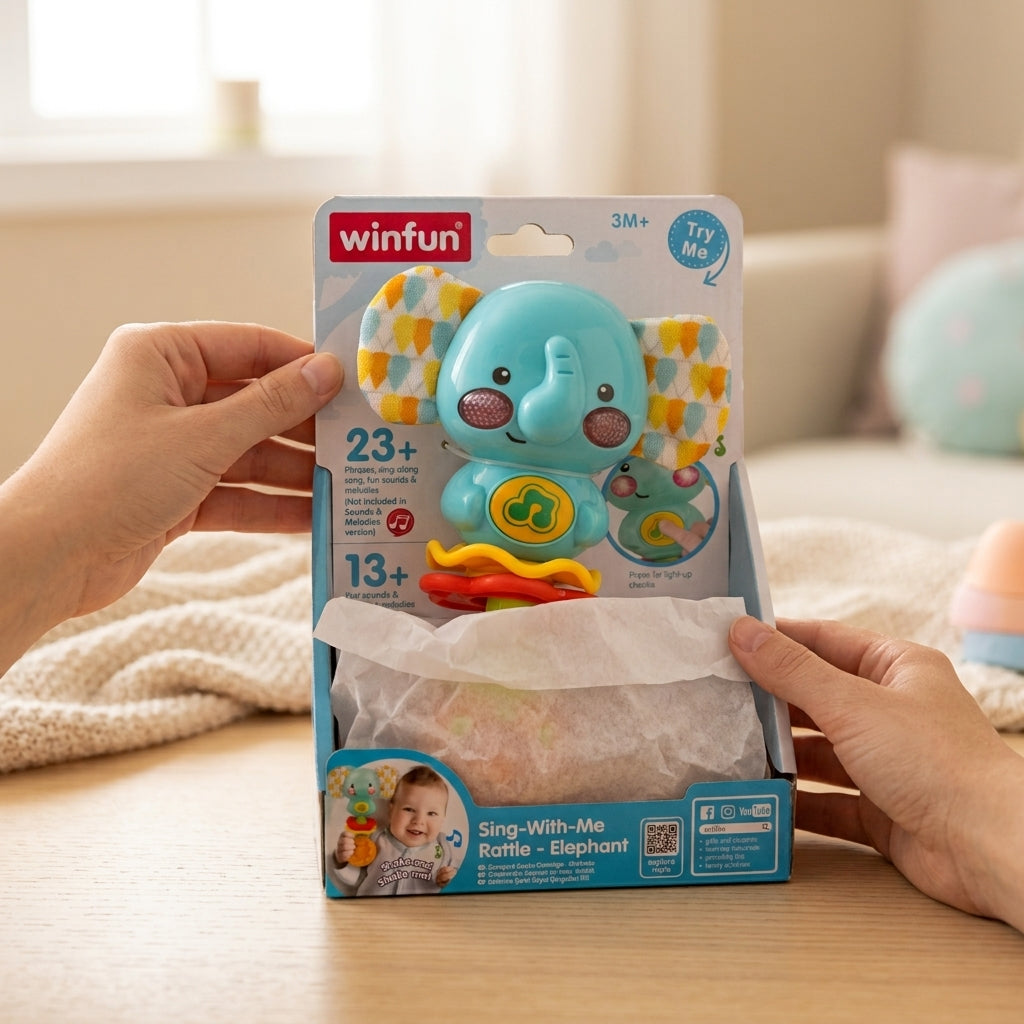Winfun elephant rattle blister pack being unwrapped on a wooden table