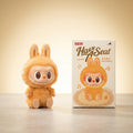 POP MART LABUBU Have A Seat plush figure beside its retail box