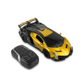 Gold RC supercar with black rear wing and its remote controller on white